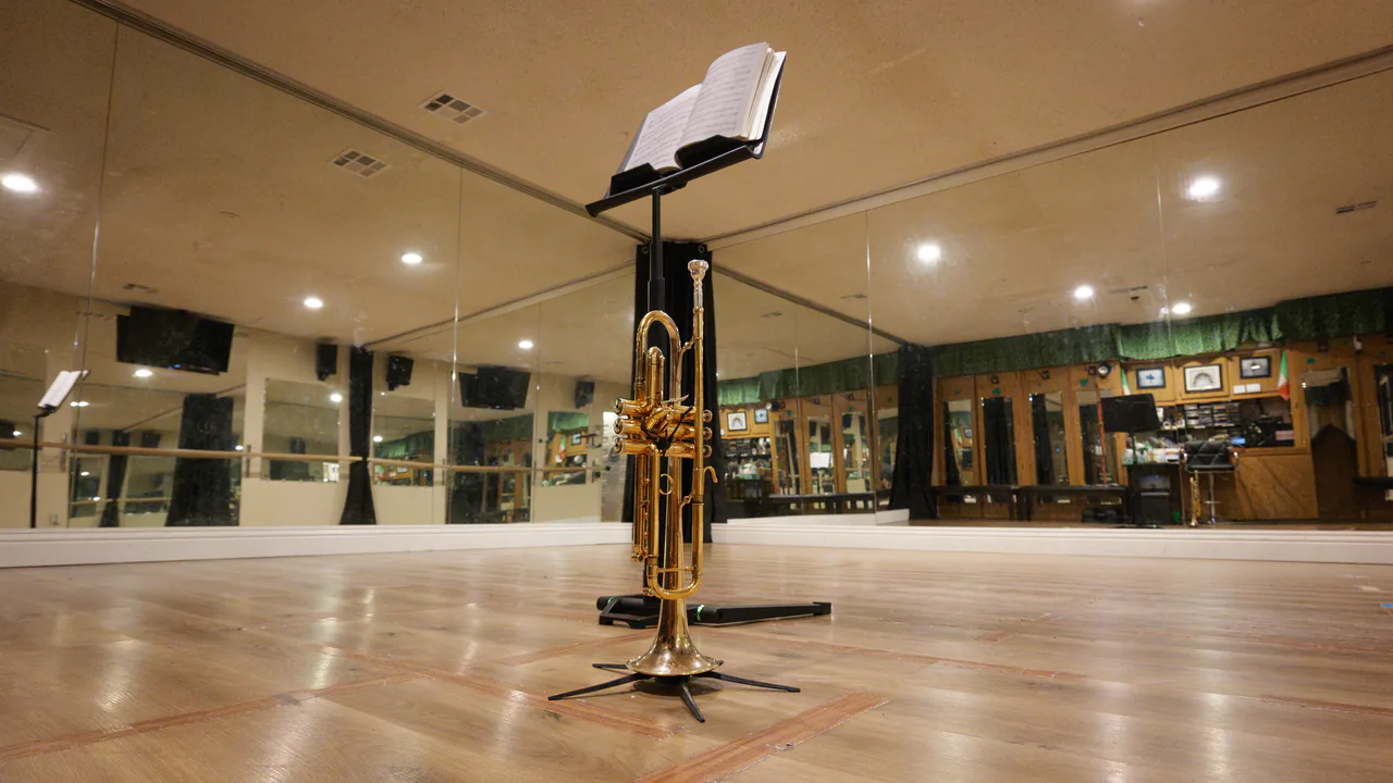 Trumpet on a stand in the mirrored private lesson studio